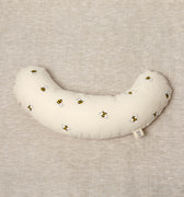 The Bee tummy time support aid helps newborn babies during their floor time. Made from a supportive wooden lining and a washable cotton cover. The fabric print has bees printed on it.