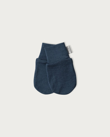 A pair of Denim Navy Merino wool mittens for babies with wrist cuff.