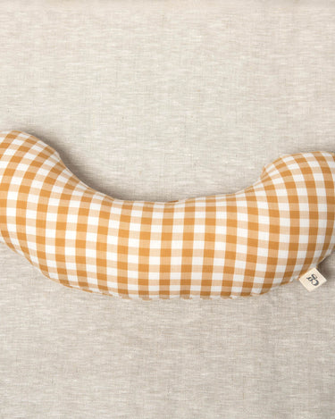 The Sonny Tummy Time support aid helps babies during floor time in their early months. Sewn in a mustard check cotton fabric.