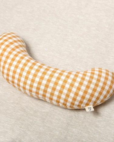 Sewn in a mustard check cotton fabric, and filled with the signature cloud filling,  The Sonny Tummy Time support aid is an excellent accessory for baby's floor time during the early months. 