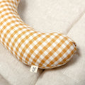 The Sonny Tummy Time support aid is a comfortable pillow that helps your baby in their early months. Sewn in a mustard check cotton fabric.