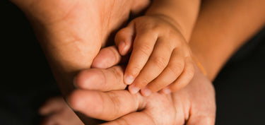 Baby and parent hand. 